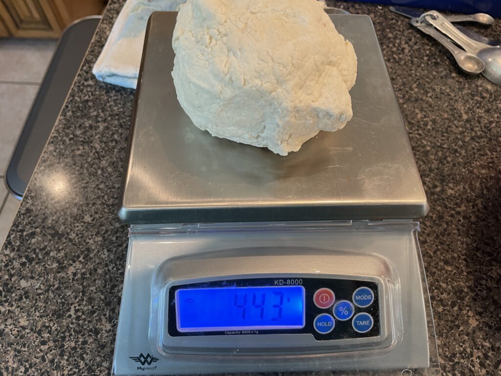 Bagel dough weighing in a 443g