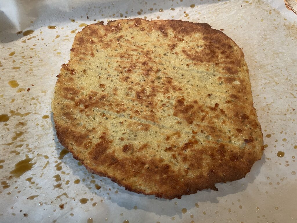 Cauliflower crust made with riced cauliflower, mozzarella cheese, flour, eggs, oregano, garlic and pepper