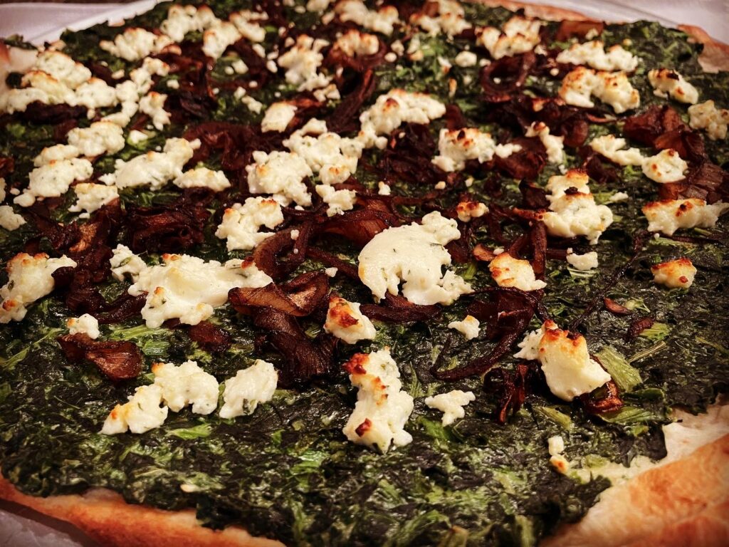 Closer view of Spinach and Caramelized Onion Pizza
