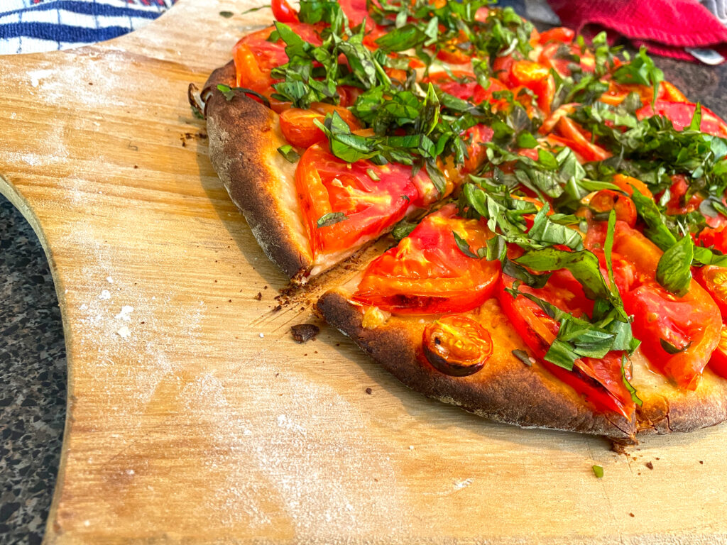 Heirloom Tomato Basil Pizza sliced and ready to serve