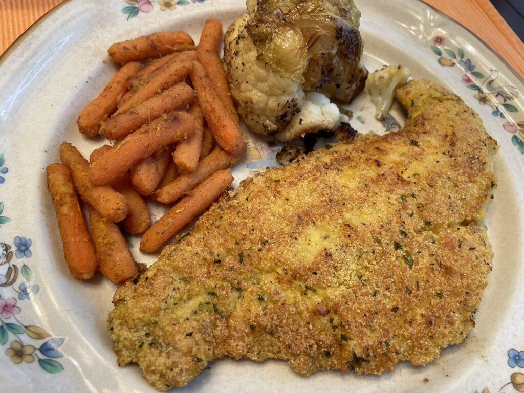 Pan-fried catfish with orange baby carrots and roasted cauliflower