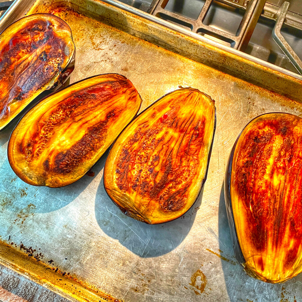 Roasted eggplant halves cooling