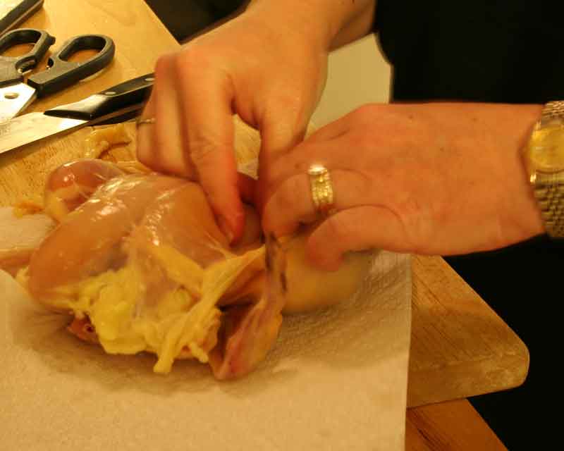 Pulling skin off the Cornish hen