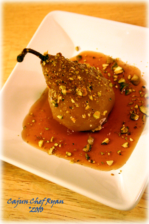 Poached Pears with Pomegranate Chardonnay Sauce, stuffed with apricots, vanilla wafers, and pistachios