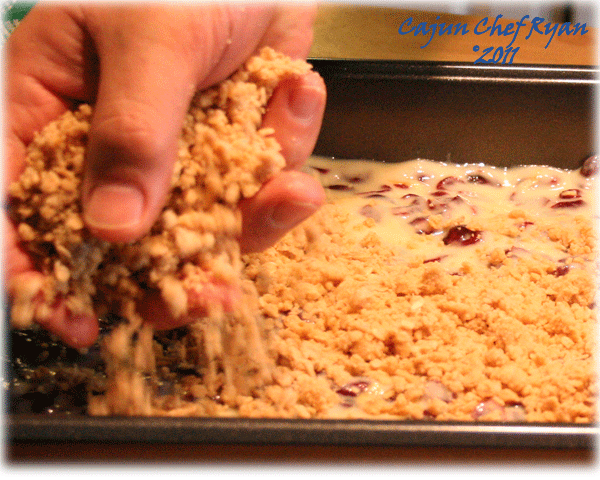 Sprinkling an even layer of oatmeal crumble for the topping crust