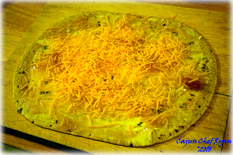 Layering cheese ingredients to the tortilla wrap